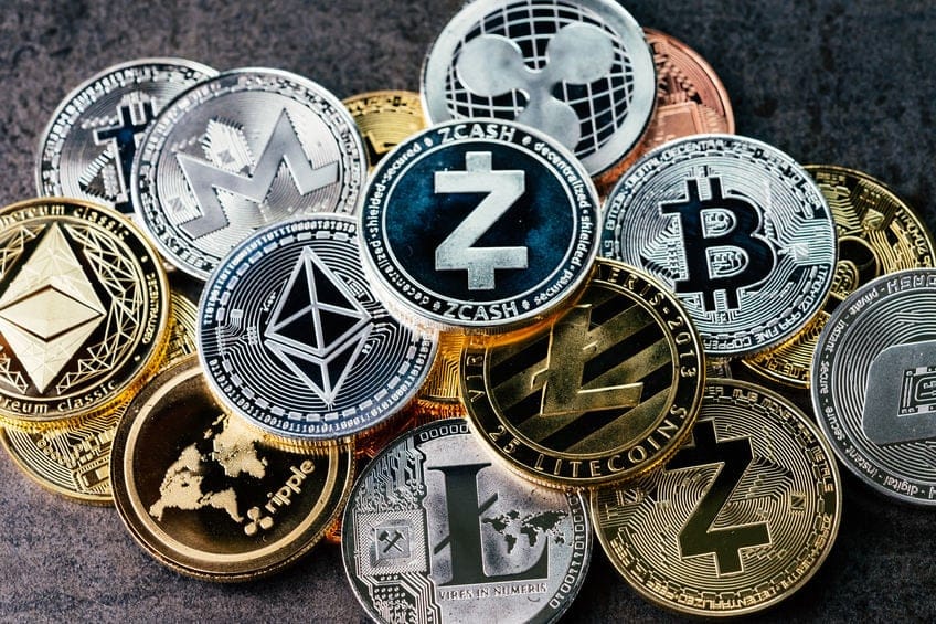 Crypto currency background with various of shiny silver and golden physical cryptocurrencies symbol coins, Bitcoin, Ethereum, Litecoin, zcash, ripple.